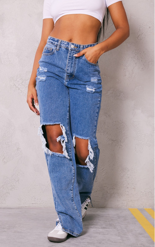 Випрані сині рвані джинси з розрізом до коліна